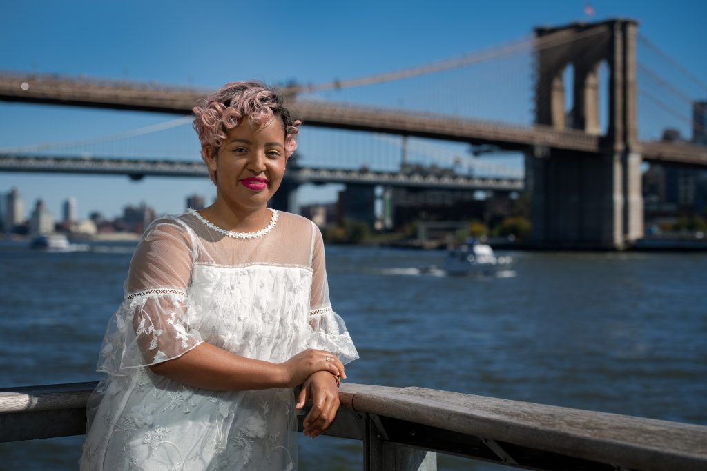 Shanaé Burch ’13 with the Brooklyn Bridge in the background  | Photo by Derek Palmer