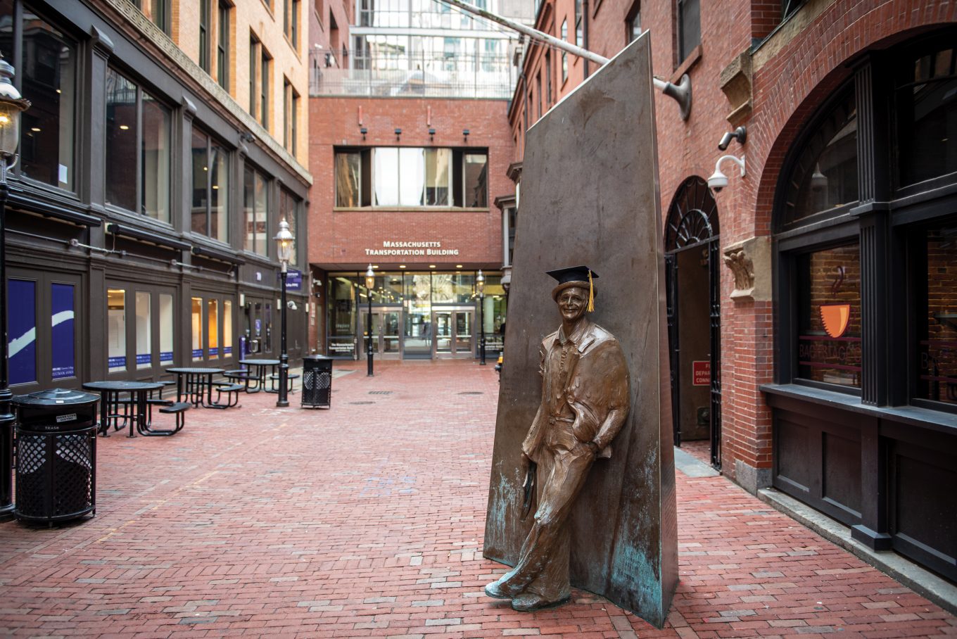 Norman Lear statue with a graduation cap in Boylston Place alley