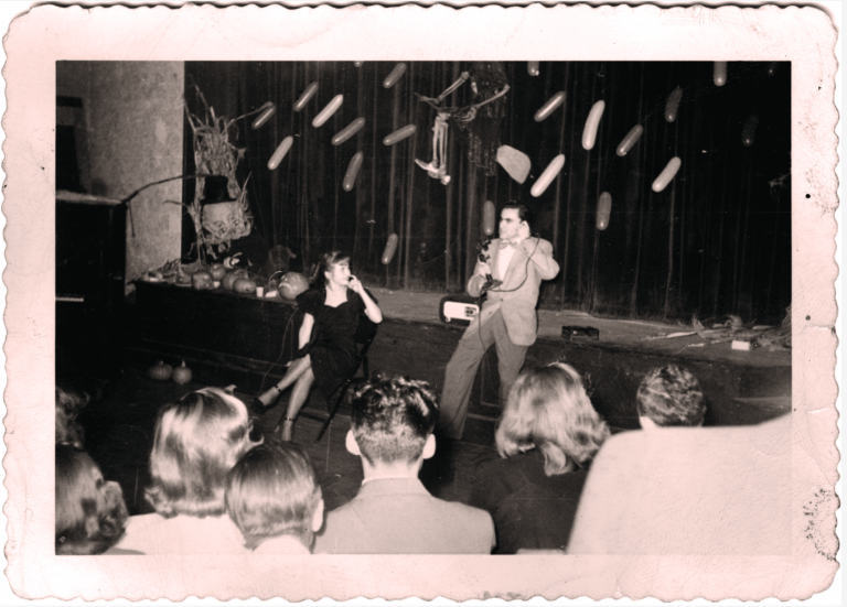 Bill Dana '50 on stage performing during a Halloween event