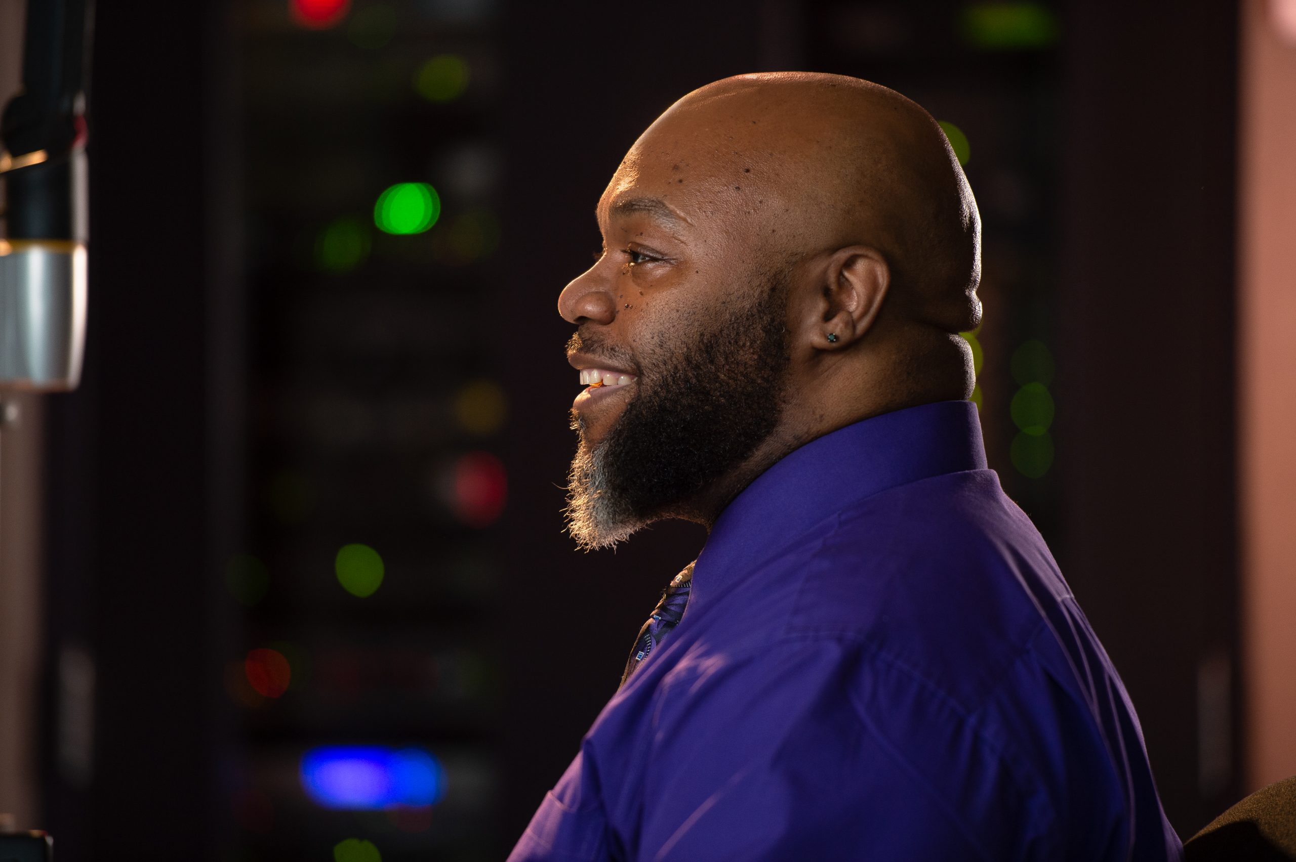 Portrait of Howard "D' Simpson in profile wearing a purple shirt