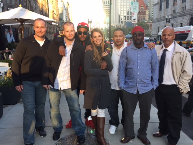 A group shot of the writers and program facilitators in Writers Without Margins standing on a sidewalk in Boston