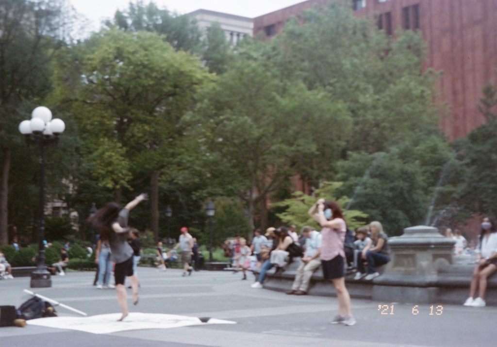 Some kids playing outside in NYC's Washington Square Park