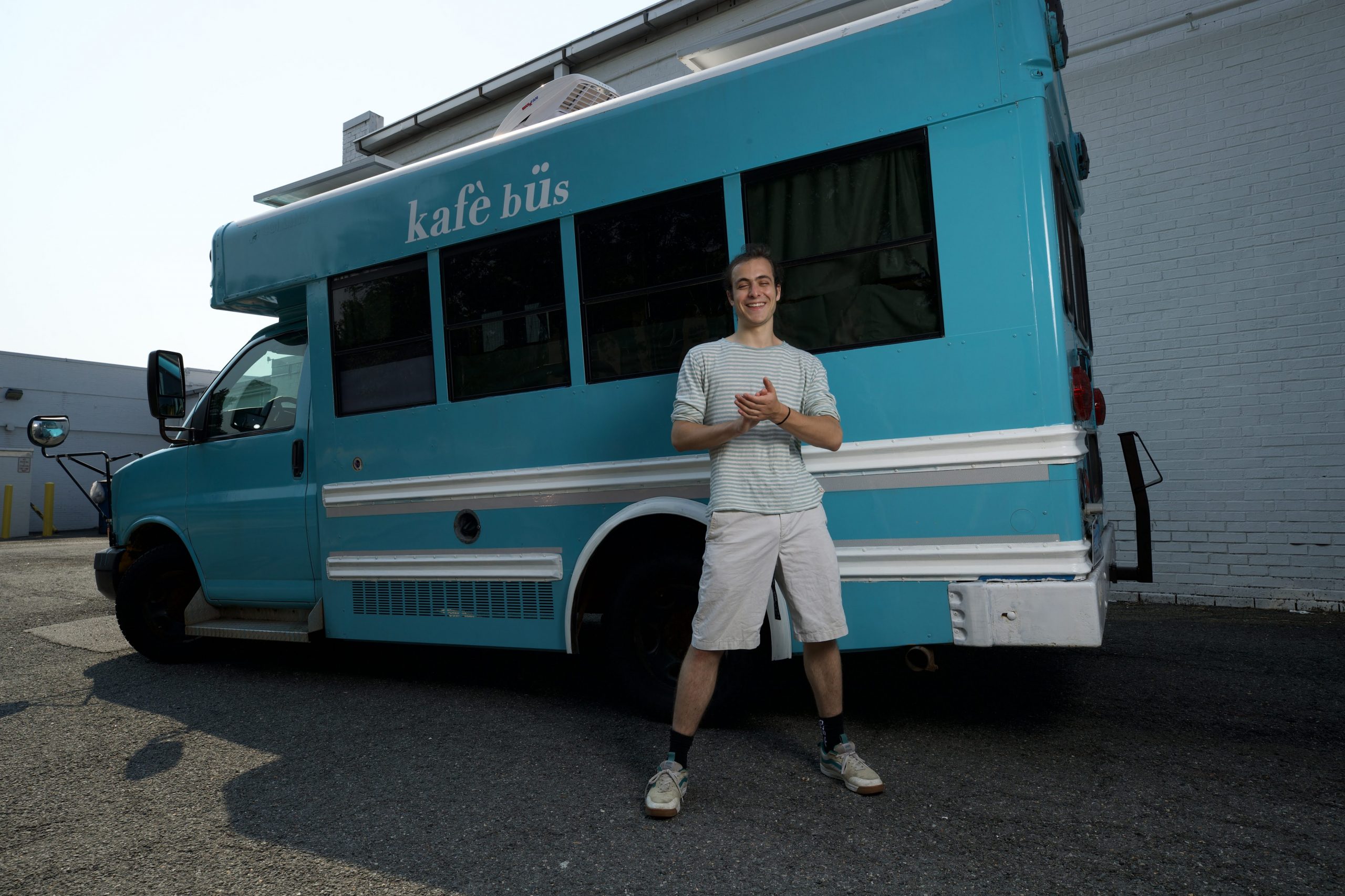 Eitan Ehrlich stands in front of a bus