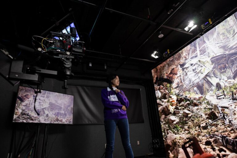Christina Yijia Ren stands in front of the virtual reality wall